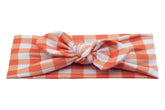 A comfortable baby head wrap featuring a gingham pattern for little girls from By Bella Boutique.